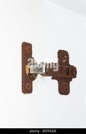 Old rusty door hinge, cabinet hinges, outdated bathroom hinge covered in rust hinge repair. High quality Stock Photo