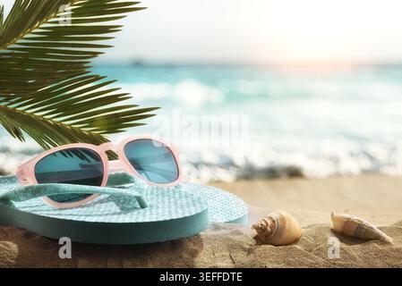 Pink sunglasses and flip flops resting on sandy beach with palm leaves, seashells, and ocean waves in soft summer sunlight. Stock Photo