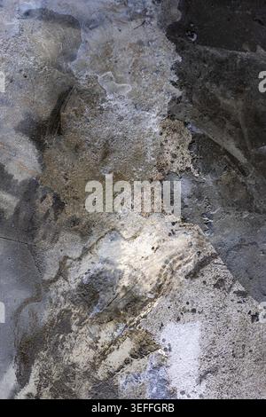 Water Stains On Concrete Surface. Abstract view of damp marks and moisture patterns on gray cement floor, suitable for industrial textures or architec Stock Photo