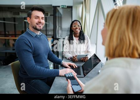 Diverse business team collaborating during meeting in modern office Stock Photo