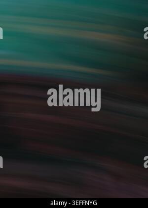 Abstract motion blur image featuring a dark teal top transitioning into a deep mahogany brown bottom. The horizontal streaks create a sense of high sp Stock Photo