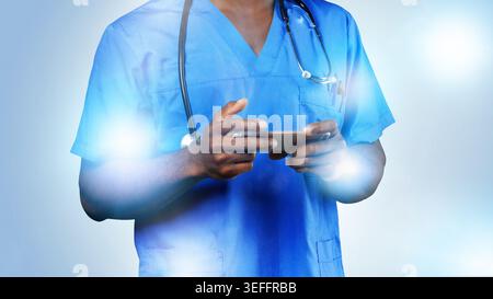 Healthcare worker uses smartphone in medical setting during daytime Stock Photo
