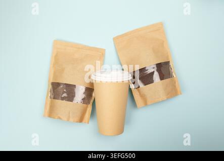 Sustainable coffee packaging with ground coffee and beans presented on a blue background in flat lay style Stock Photo