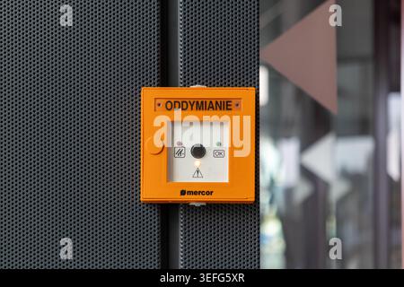 Warsaw, Poland - April 13, 2026: A close-up of a Mercor smoke ventilation button mounted on a perforated metal panel indicates fire safety, industrial Stock Photo