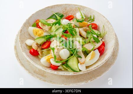 A fresh grilled chicken salad with eggs and vegetables Stock Photo