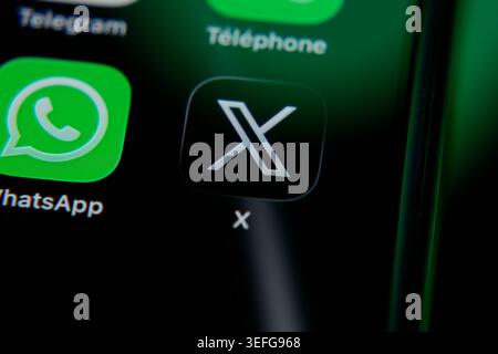 Paris, France - May 14, 2026: Close-up of the X app icon, formerly Twitter, displayed on a smartphone screen alongside WhatsApp and Telegram. Stock Photo
