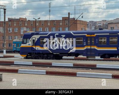 Khmelnytskyi, Ukraine - March 30, 2026: Ukrzaliznytsia train car featuring a white bicycle icon on a blue side panel, highlighting multimodal public t Stock Photo