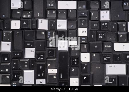 Close-up of a collection of keyboard keys from different old laptops on a table Stock Photo