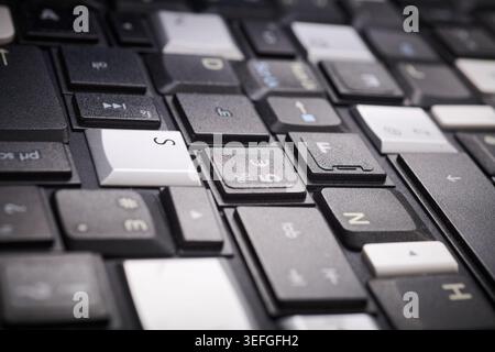 Close-up of a collection of keyboard keys from different old laptops on a table Stock Photo