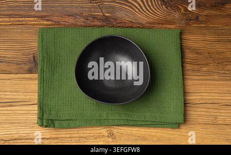 Empty Bowl Mockup, Black Plate on Wooden Table Top View with Copy Space for Text, Rustical Kitchen Mock Up, Empty Bowl with Cloth Napkin Fabric Stock Photo