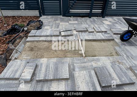 Paving work in progress, laying concrete slabs on a prepared sand bed Stock Photo