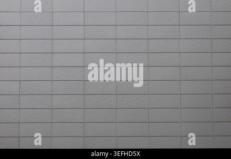 Gray porcelain stoneware tiles on ventilated facade with stone effect. Background and texture. Stock Photo