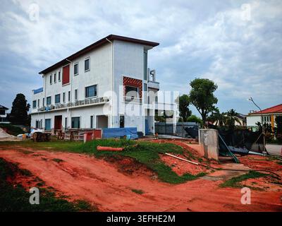 Contemporary residential house being built on a construction site with red soil Stock Photo