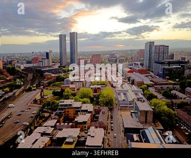 Manchester skyline looking west from Liverpool Road towards Salford at dusk, with new towers and city streets. Stock Photo
