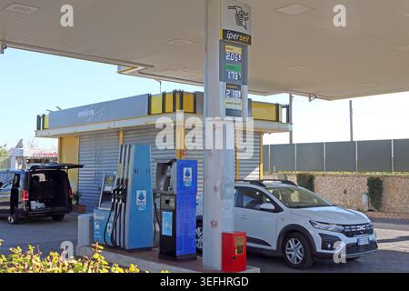 Enilive service station in Giardini Naxos, Sicily, showing petrol and diesel pump prices at an Italian forecourt Stock Photo