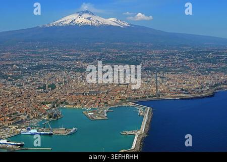 Catania port and city with snow-capped Mount Etna in the background, Sicily, Italy. Stock Photo