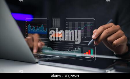 Hand using stylus on tablet with financial dashboard and data charts. Professional analyzing business statistics and stock market trends. Modern digit Stock Photo