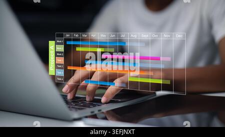Person using laptop with digital Gantt chart interface for project management. Business professional planning tasks and schedules. Modern technology w Stock Photo