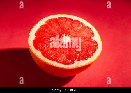 sliced grapefruit on red background Stock Photo
