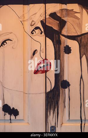 Funchal Madeira May 9th 2026 Close-up view of a stylized painting of a woman's face rendered on a light-colored wooden surface. Stock Photo