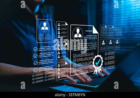 Human resources management and recruitment concept. HR manager evaluating online resume profiles and candidate curriculum vitae data on laptop Stock Photo