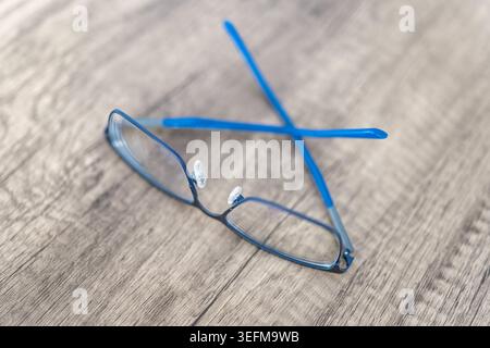 Reading glasses on wooden table. Stock Photo