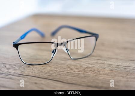 Reading glasses on wooden table. Stock Photo