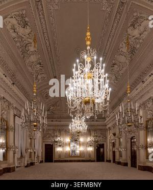 Panoramic view of an ornate palace hall with crystal chandeliers and decorated ceiling in Palazzo Pitti, Florence, Tuscany, Italy. Stock Photo