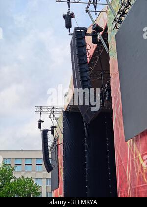 Outdoor concert stage with hanging line array speakers and a large LED ...