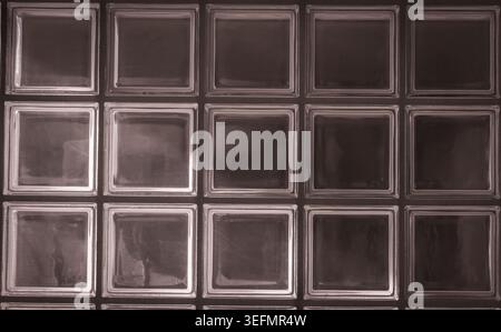 Glass block wall pattern creating abstract background with light Stock Photo