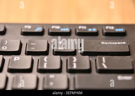 Minimal Black Keyboard Macro Detail Featuring Highlighted Equals and Plus Key in Soft Focus Angled Top View Compositions Stock Photo