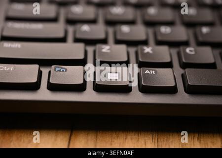 Black Computer Keyboard Macro Shot Highlighting Windows Key with Soft Blurred Backgrounds Angled Top View Stock Photo