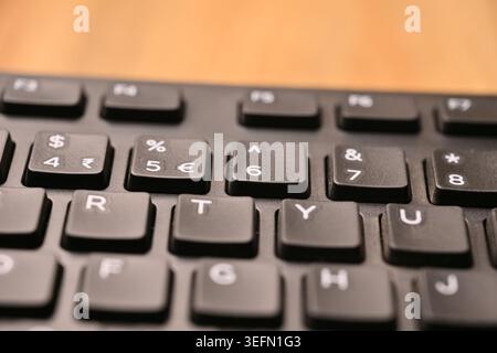 Minimal Black Keyboard Macro Detail Featuring Highlighted 6 and Caret Key in Soft Focus Angled Top View Compositions Stock Photo