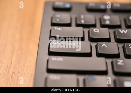 Black Computer Keyboard Macro Shot Highlighting Caps Lock Key with Angled Top View and Soft Blurred Backgrounds Stock Photo