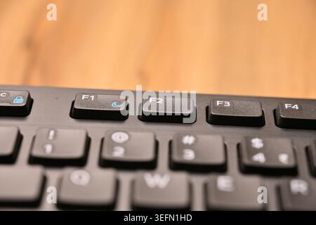 Minimal Black Keyboard Macro Compositions Highlighting F2 Function Key in Soft Focus Angled Top View Stock Photo