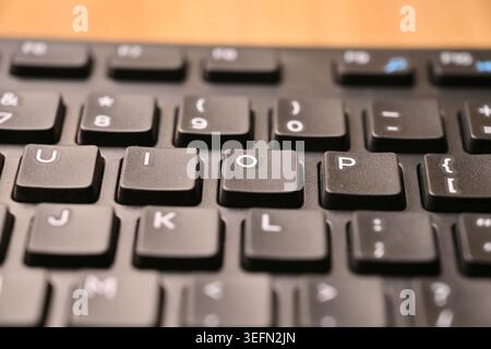 Minimal Black Keyboard Macro Detail Featuring Highlighted O Key in Soft Focus Angled Top View Compositions Stock Photo