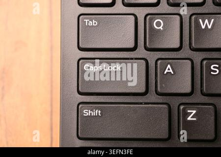 Black Computer Keyboard Macro Shot Highlighting Caps Lock Key with Soft Blurred Backgrounds Top View Stock Photo