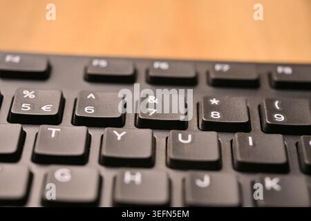 Minimal Black Keyboard Macro Detail Featuring Highlighted 7 and Ampersand Key in Soft Focus Angled Top View Compositions Stock Photo