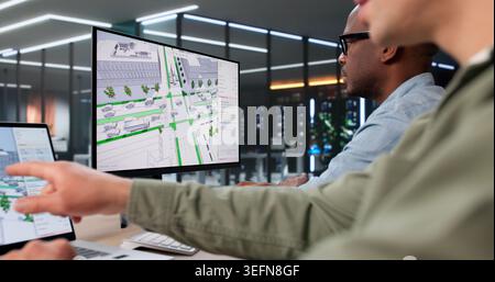 Two Civil Engineers Use 3D Software Analyzing Urban Road Traffic Flow Data. Stock Photo
