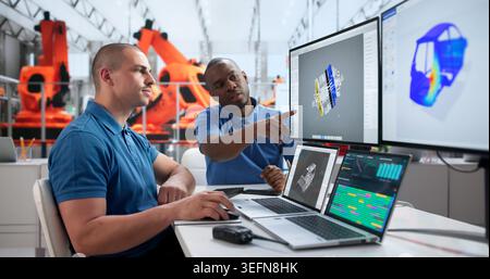 Young African Automotive Engineer Uses Simulation Software For Precise Vehicle Analysis. Stock Photo
