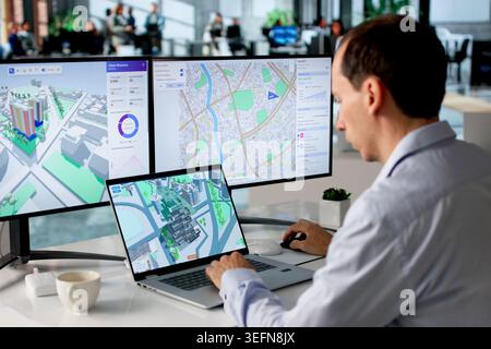 Engineer Studies Urban Property Maps On Laptop Using BIM And GIS Software. Stock Photo