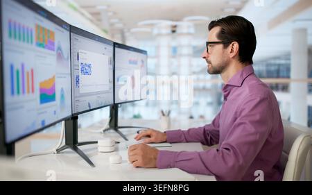 Mature Man Analyzes Financial Charts On Computer To Manage Corporate Performance. Stock Photo