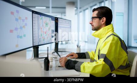 Experienced Police Analyst Studies Crime Patterns Using Advanced Geospatial Software. Stock Photo