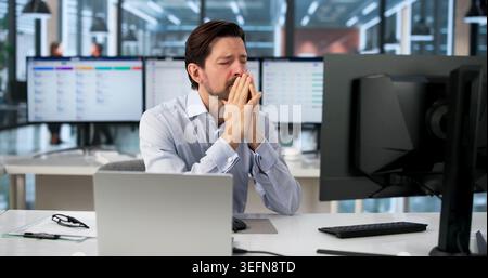 Tired Man Rubbing Swollen Sore Eye From Computer Screen Strain At Desk. Stock Photo