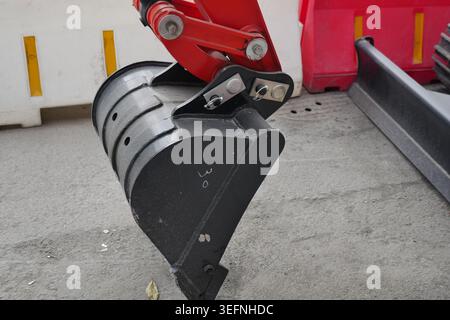 Excavator bucket attachment on construction site Stock Photo