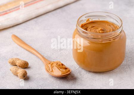 Peanut paste in an open jar Stock Photo