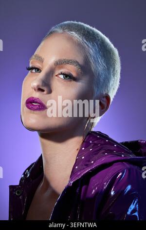 Fashion, makeup and portrait of woman in studio for colorful aesthetic or purple apparel. Cosmetics, serious and style with person in clothes outfit Stock Photo