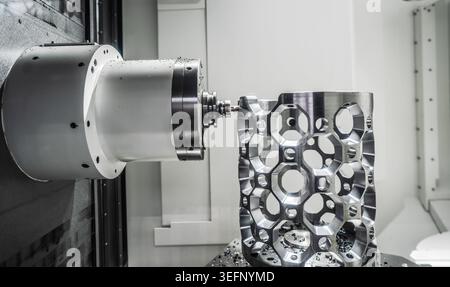 CNC milling machine processing an aluminum aerospace part.Precision CNC milling of an aluminum metal component in industrial machining center with vis Stock Photo