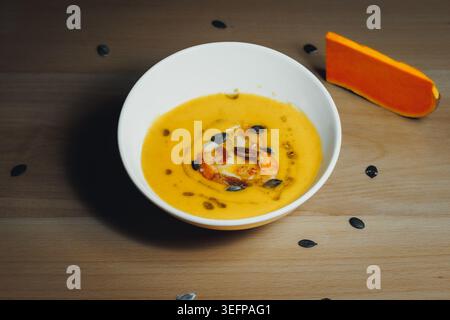 Golden pumpkin soup with seeds and crouton Stock Photo