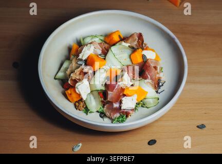 Plump, juicy melons, crisp cucumber, and lean meat slices on a plate Stock Photo